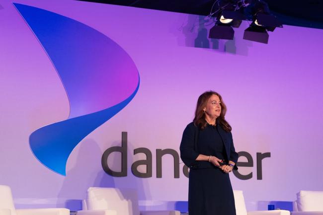 Joan Larovere gives a speech on stage at the Danaher Summit