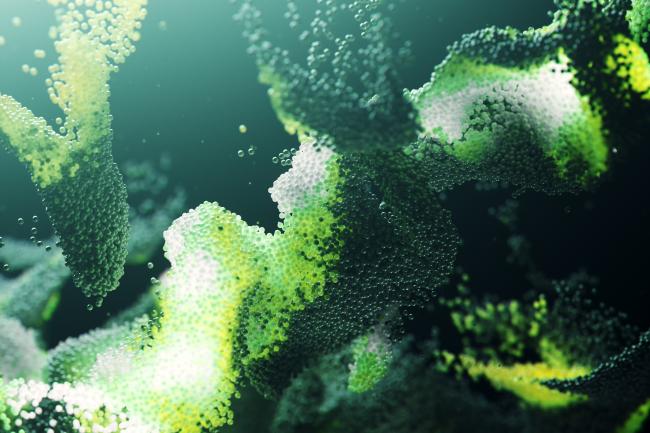 Small green particles twist and turn to form and organic molecule-like structure